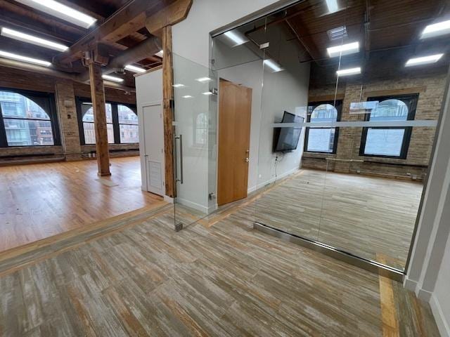 interior space featuring hardwood / wood-style floors and decorative columns