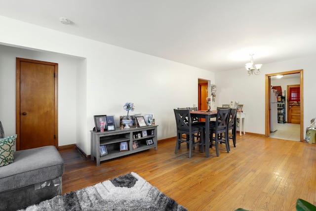 dining room featuring wood-type flooring and a notable chandelier