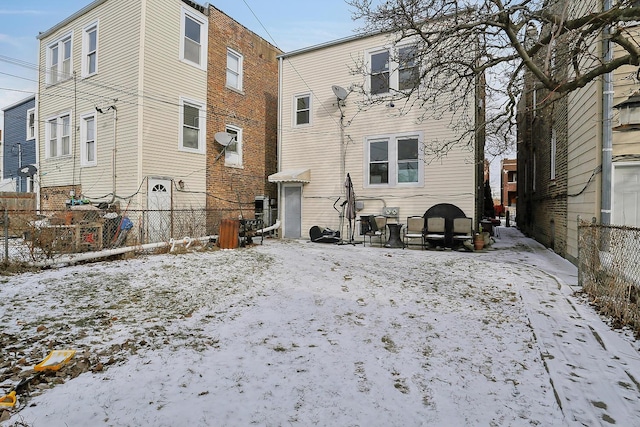 view of snow covered rear of property