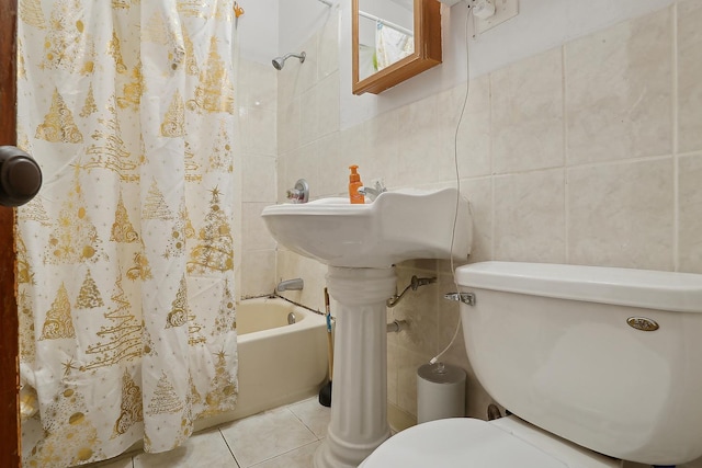 bathroom with shower / tub combo, tile walls, tile patterned floors, and toilet