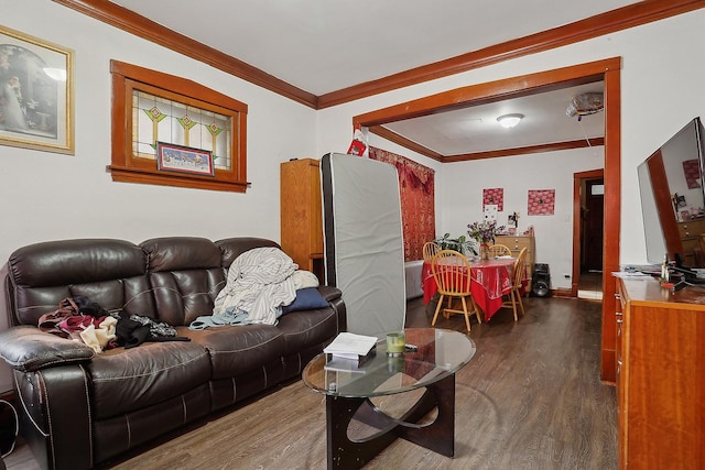 living room with dark hardwood / wood-style flooring and crown molding