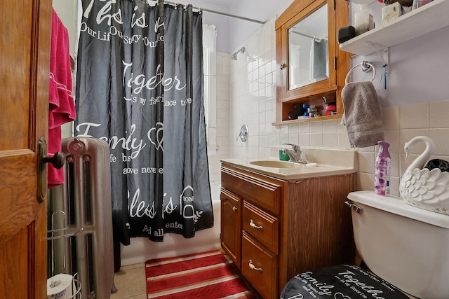 full bathroom featuring toilet, tile walls, radiator heating unit, vanity, and backsplash