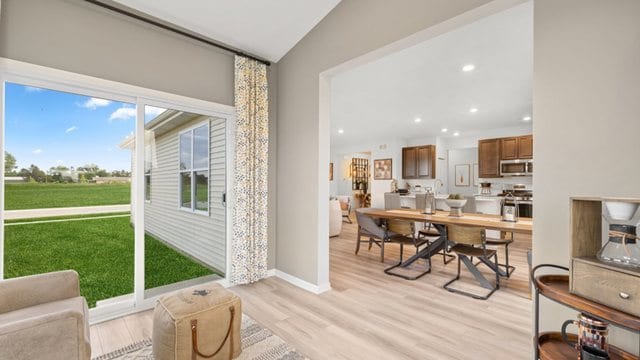 dining space featuring vaulted ceiling and light hardwood / wood-style flooring