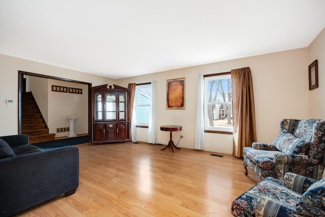 living area with visible vents, plenty of natural light, and light wood finished floors