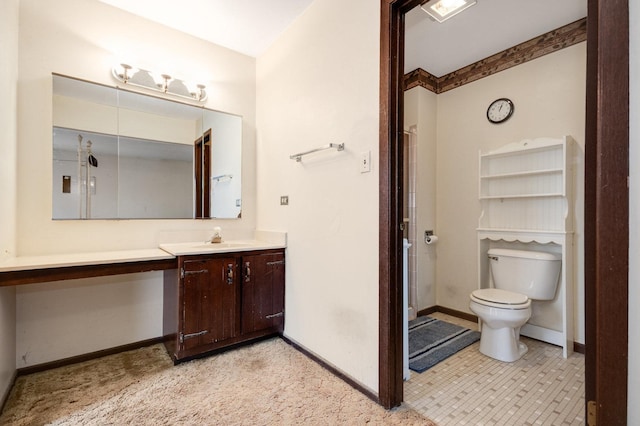 full bath featuring toilet, a stall shower, vanity, and baseboards