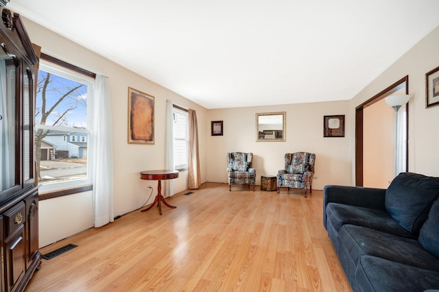 living room featuring visible vents and light wood finished floors