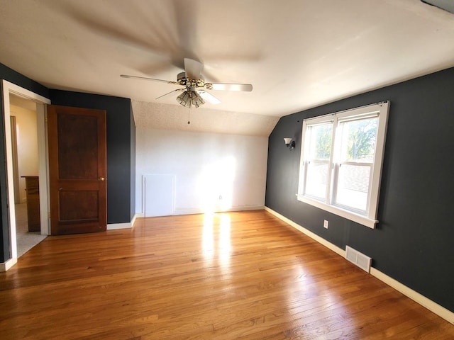 additional living space with lofted ceiling, ceiling fan, and light wood-type flooring