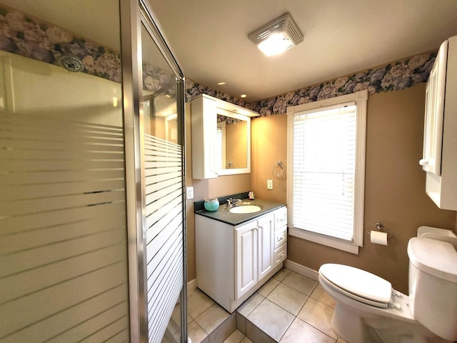 bathroom featuring tile patterned flooring, vanity, plenty of natural light, and toilet