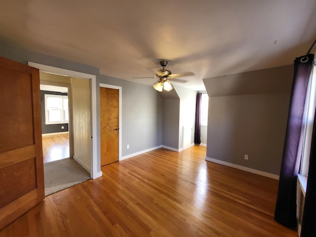 bonus room with ceiling fan, a healthy amount of sunlight, and light wood-type flooring