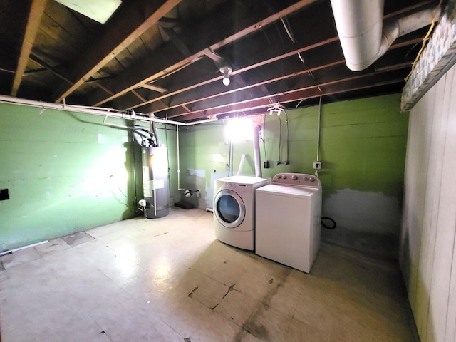 basement featuring gas water heater and separate washer and dryer