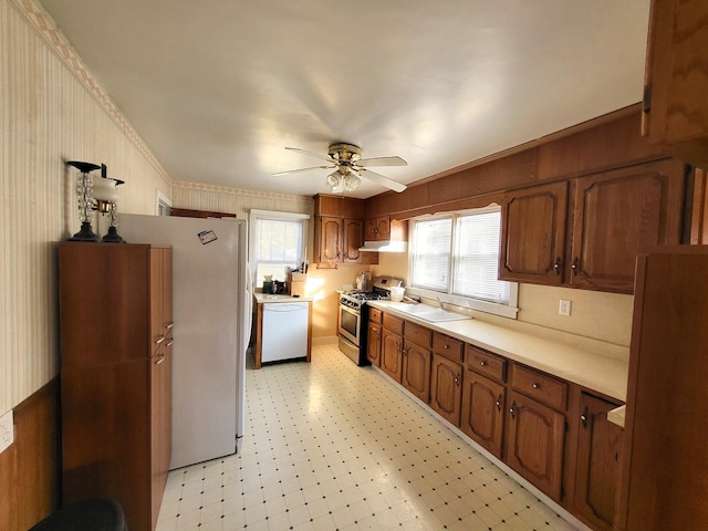 kitchen featuring sink, ceiling fan, dishwasher, ornamental molding, and gas stove