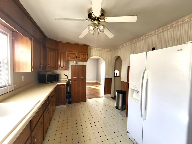 kitchen with white refrigerator with ice dispenser and ceiling fan