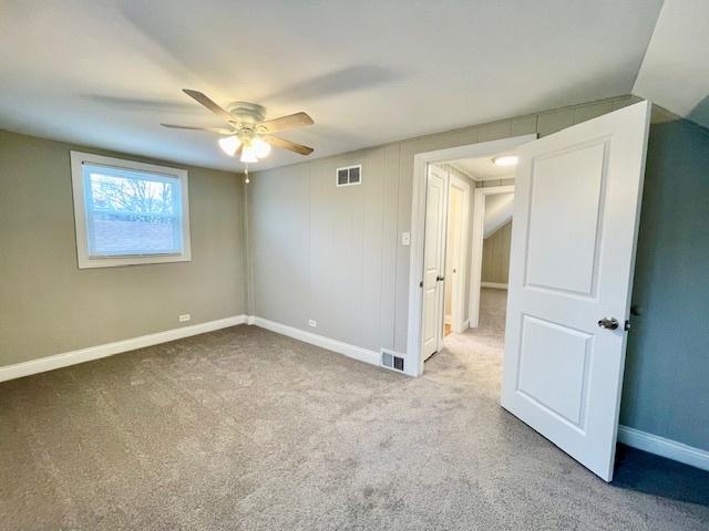 unfurnished bedroom with light carpet and ceiling fan