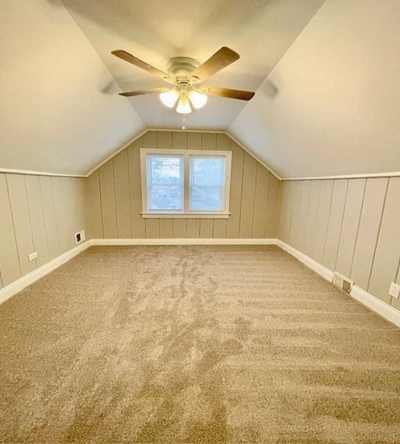 bonus room with vaulted ceiling, carpet, and ceiling fan