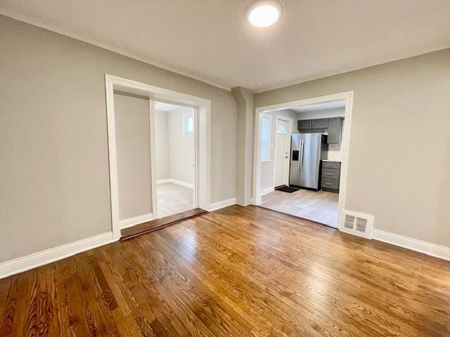 unfurnished room with hardwood / wood-style floors