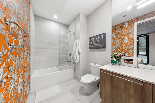 full bathroom with tiled shower / bath, tile patterned floors, toilet, and vanity