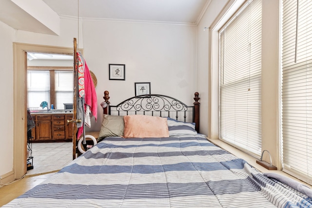 bedroom with light tile patterned floors and crown molding