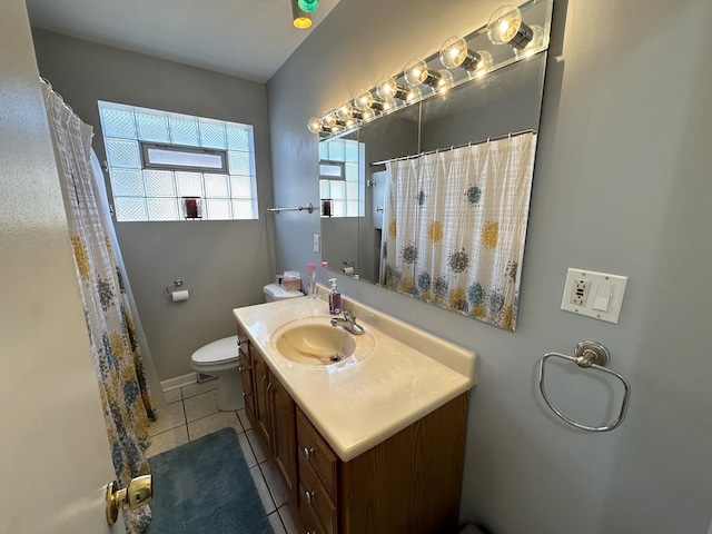 bathroom featuring tile patterned flooring, vanity, and toilet