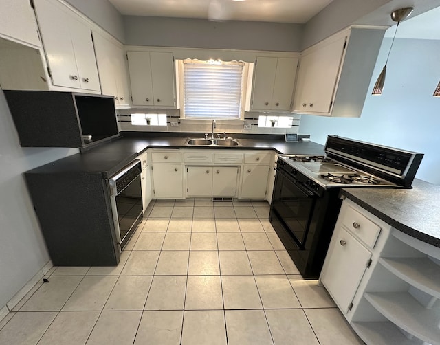 kitchen with sink, light tile patterned floors, white cabinets, and black appliances