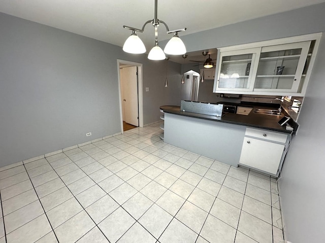 kitchen with sink, white cabinetry, light tile patterned floors, pendant lighting, and ceiling fan