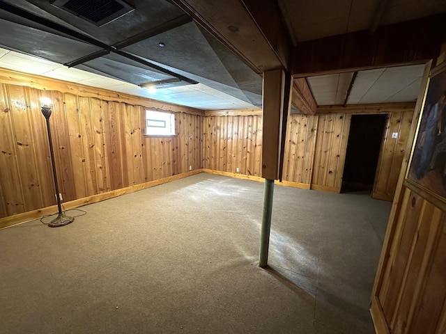 basement featuring carpet flooring and wooden walls