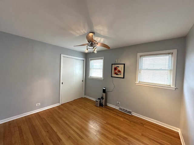 spare room with hardwood / wood-style floors and ceiling fan