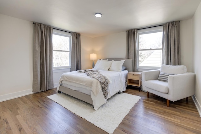 bedroom with wood finished floors and baseboards