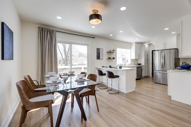dining space with baseboards, recessed lighting, and light wood-style floors