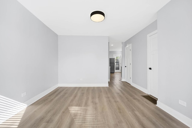 spare room featuring light wood-type flooring