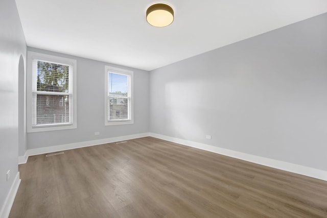 unfurnished room with wood-type flooring