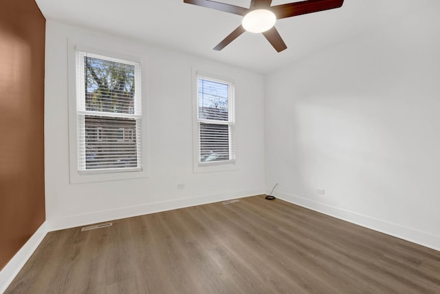 empty room with hardwood / wood-style flooring and ceiling fan