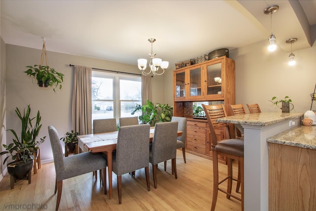 dining room featuring light hardwood / wood-style floors and a chandelier