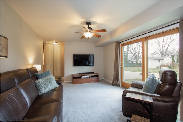 carpeted living room with ceiling fan