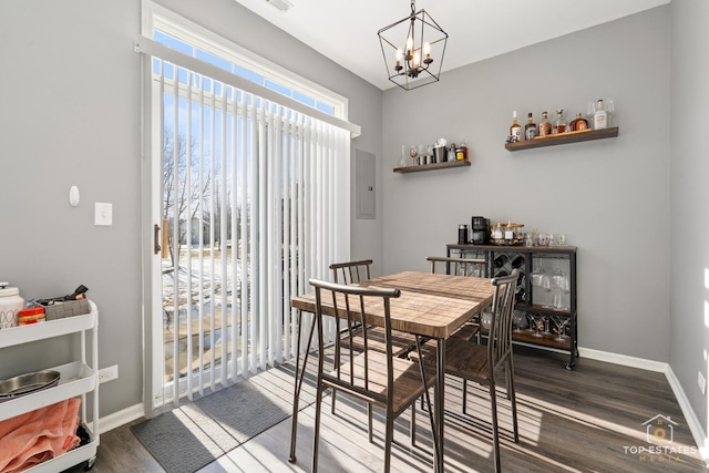 dining room with hardwood / wood-style flooring and a notable chandelier