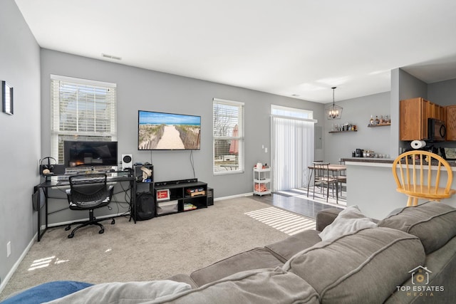 living room with a chandelier and light carpet