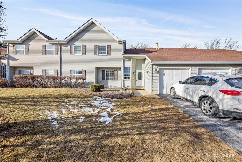 view of front of property featuring a garage and a front yard