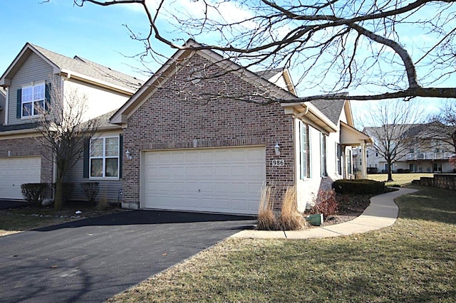 view of side of property featuring a garage and a yard