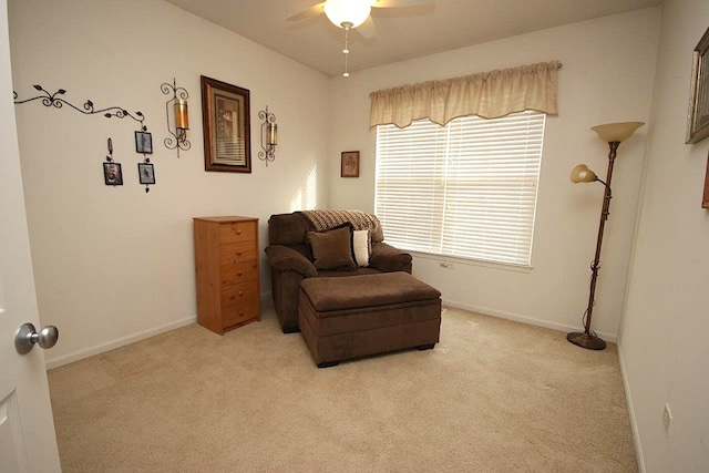 living area with ceiling fan and light carpet