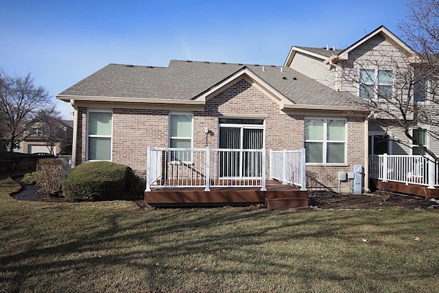 back of house featuring a wooden deck and a lawn