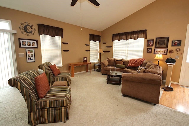 carpeted living room with high vaulted ceiling and ceiling fan