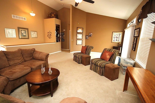 carpeted living room featuring ceiling fan and high vaulted ceiling