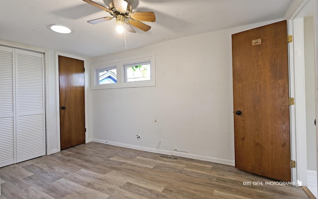 unfurnished bedroom with ceiling fan and light hardwood / wood-style flooring