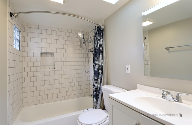 full bathroom featuring vanity, shower / bath combination with curtain, and toilet