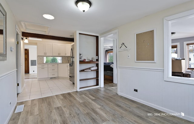 kitchen featuring light hardwood / wood-style flooring and white cabinets