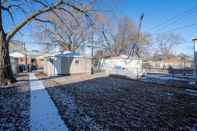 snowy yard with a storage shed