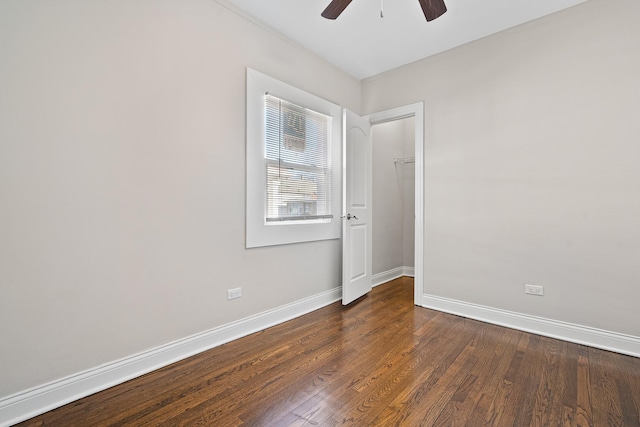 unfurnished room featuring ceiling fan and dark hardwood / wood-style floors