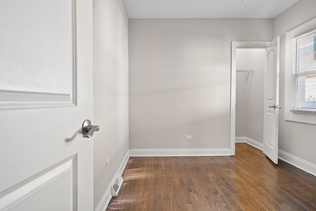 empty room with dark hardwood / wood-style floors