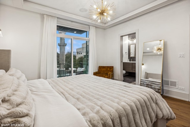 bedroom with connected bathroom, access to exterior, hardwood / wood-style floors, and a chandelier