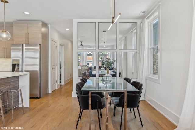 dining room featuring ceiling fan and light wood-type flooring