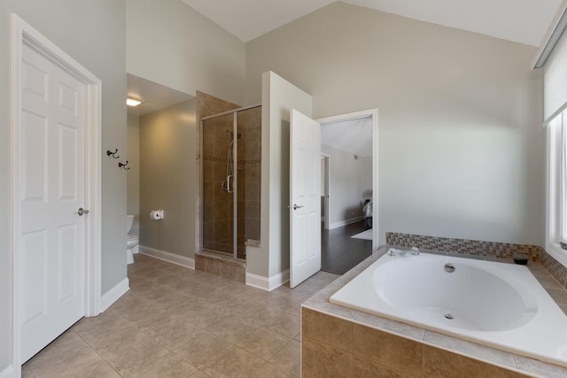 bathroom featuring vaulted ceiling, tile patterned floors, plus walk in shower, and toilet